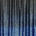 A draped sample of ombre stretch mesh sequin in the color black-blue.