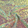 A swirled sample of opulence stretch mesh sequin in the color spring green.