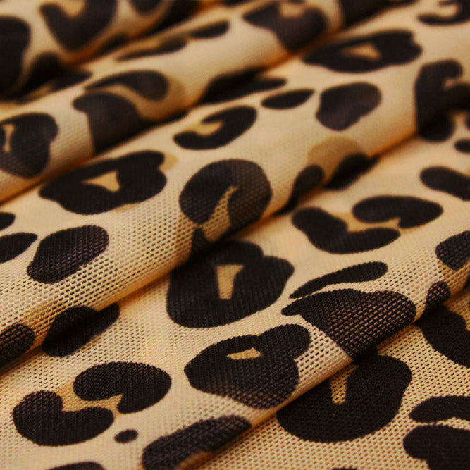 A sample of Cream Leopard Printed Power Mesh and a ruler for scale. Design includes leopard prints in a neutral background.