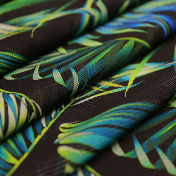 A folded sample of blue shade palms printed power mesh.