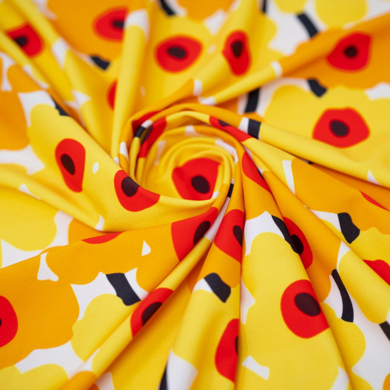 Detailed shot of swirled piece of Painted Flower Power Printed Spandex in color White Yellow.