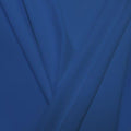 A pleated piece of performance nylon spandex fabric in the color blue bird.