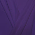 A pleated piece of performance nylon spandex fabric in the color morada.