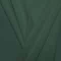 A pleated piece of performance nylon spandex fabric in the color pale cacti.