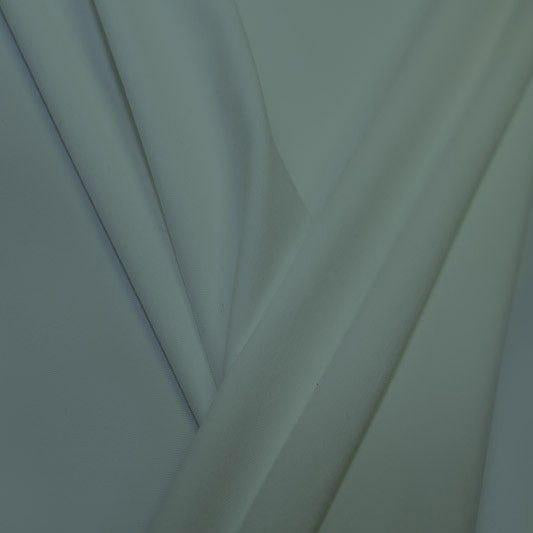 A pleated piece of performance nylon spandex fabric in the color succulent.