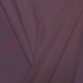 A pleated piece of performance nylon spandex fabric in the color toasted mauve.