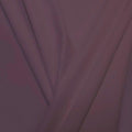 A pleated piece of performance nylon spandex fabric in the color toasted mauve.