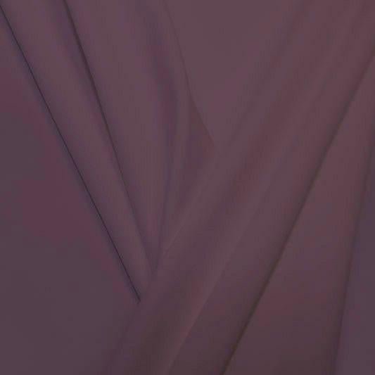 A pleated piece of performance nylon spandex fabric in the color toasted mauve.