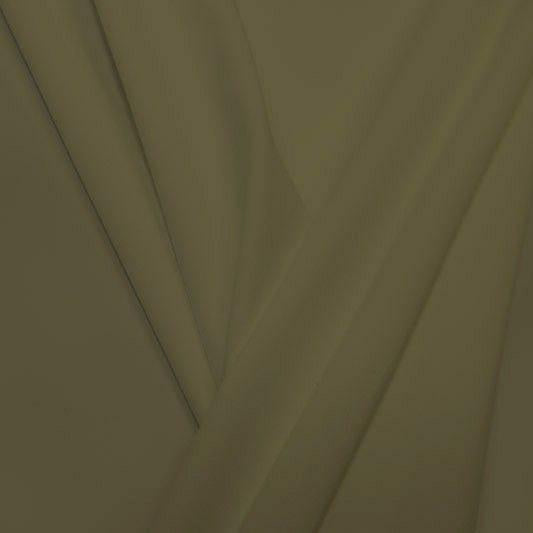 A pleated piece of performance nylon spandex fabric in the color verdant seed.