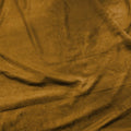 A flat sample of pocahontas stretch faux suede in the color light camel.