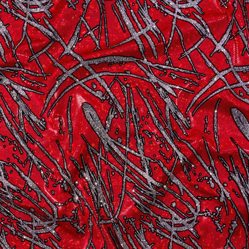 A flat sample of pollock shttered glass foiled spandex in the color red.