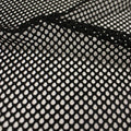 A swirled sample of pop mesh stretch netting in the color black.