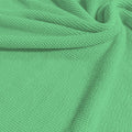 A swirled sample of popcorn polyester spandex jacquard in the color menthol.