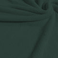 A swirled sample of popcorn polyester spandex jacquard in the color pale cacti green.
