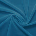 A swirled piece of nylon spandex power mesh in the color abyss.