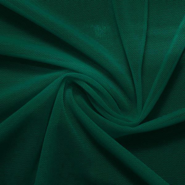 A swirled piece of nylon spandex power mesh in the color alpine green.