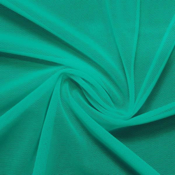 A swirled piece of nylon spandex power mesh in the color aqua tides.