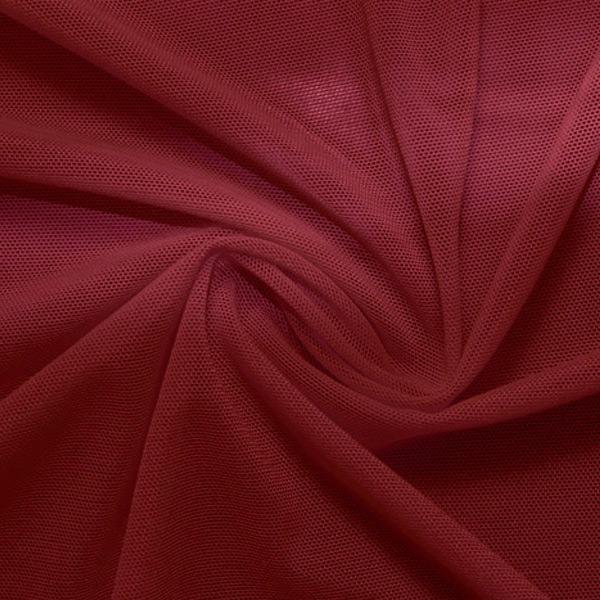 A swirled piece of nylon spandex power mesh in the color burgundy.