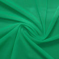 A swirled piece of nylon spandex power mesh in the color cool green.