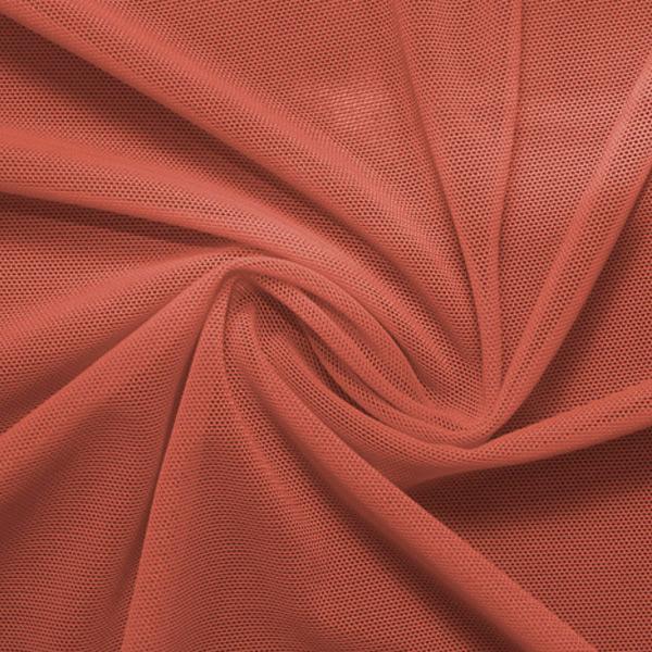 A swirled piece of nylon spandex power mesh in the color copper.