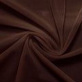 A swirled piece of nylon spandex power mesh in the color dark brown.