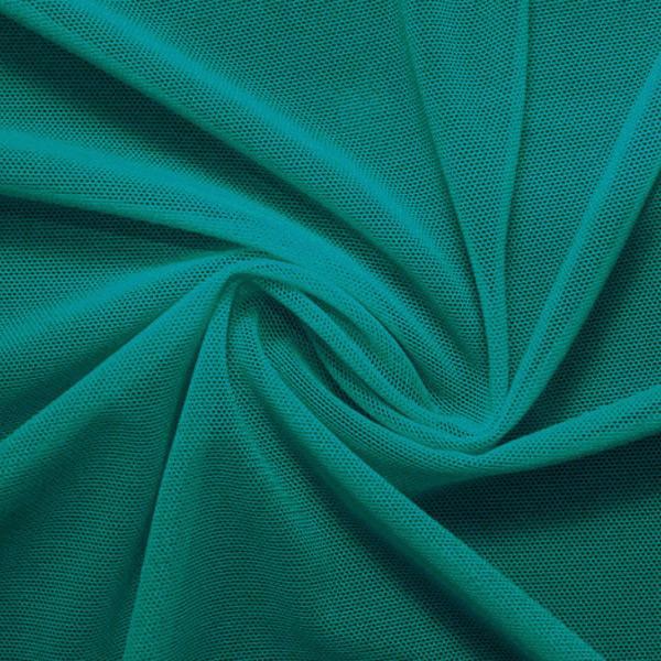 A swirled piece of nylon spandex power mesh in the color emerald.