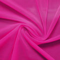 A swirled piece of nylon spandex power mesh in the color fuchsia.