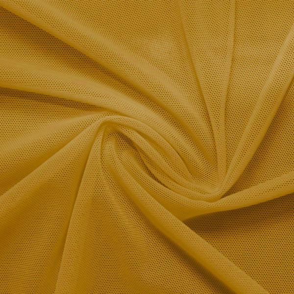 A swirled piece of nylon spandex power mesh in the color golden.