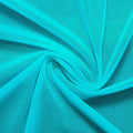A swirled piece of nylon spandex power mesh in the color light turquoise.
