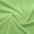 A swirled piece of nylon spandex power mesh in the color lucky charm.