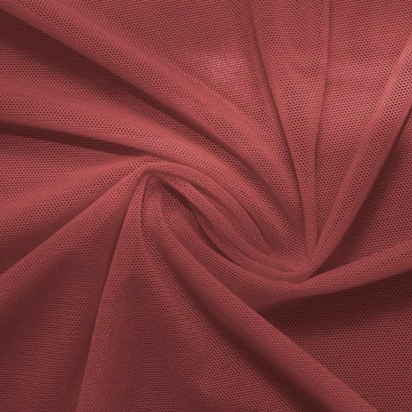 A swirled piece of nylon spandex power mesh in the color mars.