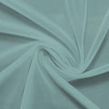 A swirled piece of nylon spandex power mesh in the color moonstone.