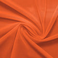 A swirled piece of nylon spandex power mesh in the color penny.