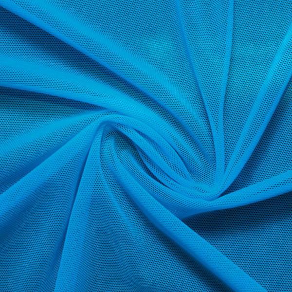A swirled piece of nylon spandex power mesh in the color turquoise.