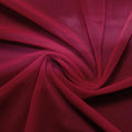 A swirled piece of nylon spandex power mesh in the color wine.