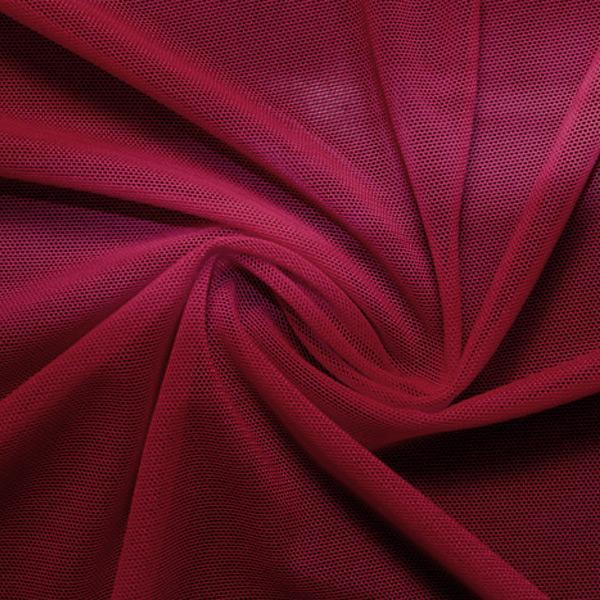 A swirled piece of nylon spandex power mesh in the color wine.