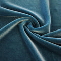 A swirled sample of primo stretch velvet in the color aquamarine blue.