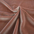 A swirled sample of primo stretch velvet in the color topaz.