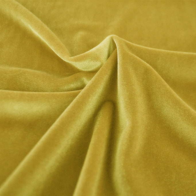 A swirled sample of primo stretch velvet in the color yellow.