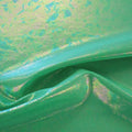 A swirled sample of popcorn polyester spandex jacquard in the color green.