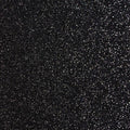 A flat sample of radiance heat transfer glitter in the color black.