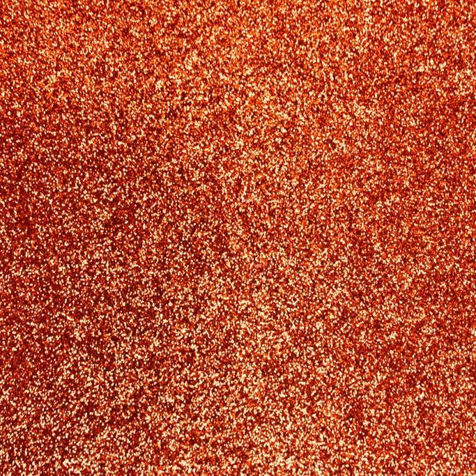 A flat sample of radiance heat transfer glitter in the color orange.