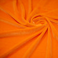 A swirled sample of regal matte stretch velvet in the color Neon-Orange
