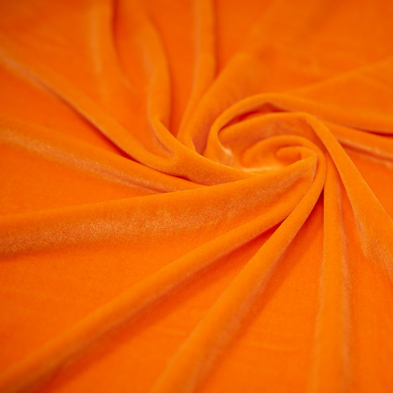 A swirled sample of regal matte stretch velvet in the color Neon-Orange