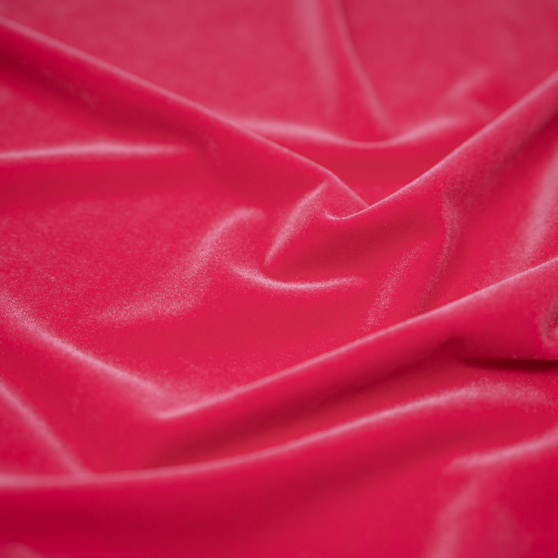 A swirled sample of regal matte stretch velvet in the color Neon-Pink