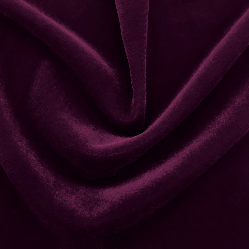 A swirled sample of regal matte stretch velvet in the color eggplant purple.