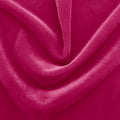 A swirled sample of regal matte stretch velvet in the color hot pink.