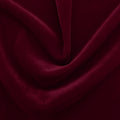 A swirled sample of regal matte stretch velvet in the color wine red.