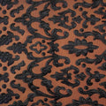 A flat sample of renee embroidered mesh in the color black-orange.