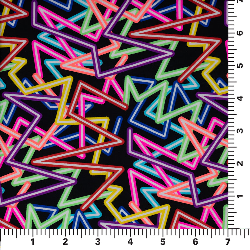 Flat sample shot of Retro Neon Lights Printed Spandex Fabric on a 7"x7" ruler for pattern scale. The print is of zig-zag neon strobes in various colors of red, yellow, neon pink, light green, hot coral and blue with white as the filling on a black background.